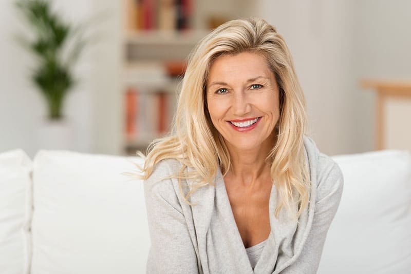 attractive mature woman showing off her confident smile with dentures