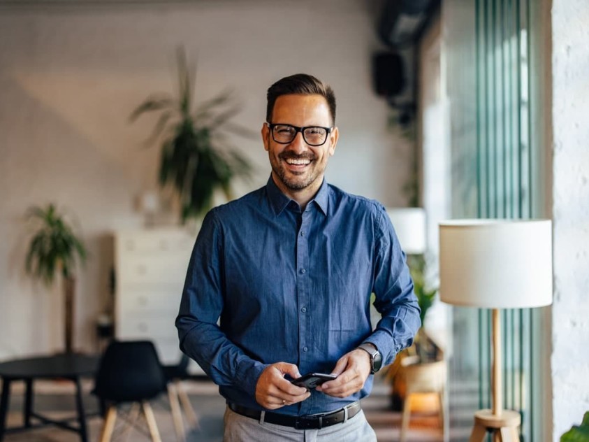 man in blue shirt smiling with teeth